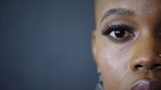 Optometry, face and woman with focus in studio for optical assessment, glaucoma exam or retina scan. Eyecare, vision and black person with eye test on gray background for prescription, sight or space
