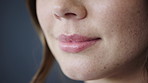 Cosmetics, lips and woman with smile in studio for dermal filler, synthetic hyaluronic acid and results. Dermatology, person or mouth closeup on gray background with HA treatment, volume or aesthetic