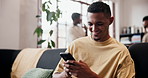 Happy, typing and man on sofa, smartphone for social media and digital app for online humor. Smile, laughing and person in home, funny meme and cellphone for chatting, scroll and message to contact