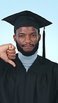 Face, student and thumbs down at graduation in studio for feedback, academic fail and poor decision. Portrait, black man and disappointed for learning experience, wrong degree and white background