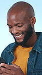 Happy, man and texting with smartphone in studio, laughing and communication with contact on website. Blue background, online and black person with mobile for funny chat, typing and message on app