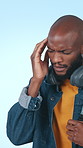 University student, headache and black man in studio, pain and tension on blue background. Stress, pressure and person with migraine, frustrated and depression with mental health for scholarship