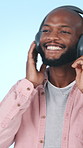 Headphones, dance and black man in studio with music for positivity, good mood and relax on weekend. Student, streaming and person listening to audio, radio and playlist for energy on blue background