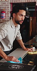 Cleaning, serious and thinking with man in coffee shop for disinfection of countertop or hygiene. Cloth, surface and wipe with barista in cafe or restaurant for management of small business as owner