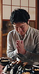 Bow, food and respect with Japanese man in dining room for family feast, meal or tradition. Culture, prayer and thank you with person at table in apartment for Asian cuisine, bonding or hunger