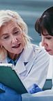Scientist, team and feedback with tablet at laboratory with talk, discussion and medical research. Mature people, collaboration and checklist with tech, pharma study or app for vaccine development