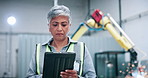 Engineer, robotics and mature woman on tablet in factory for assembly line, software and inspection. Automation, online and person on digital tech for system diagnostics, design or technical manual