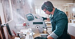 Bandsaw, carpentry and dust with man in warehouse for manufacturing or production process. Goggles, ppe and sawing machine with person in woodworking plant to resize lumber or timber for project