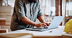 Hands, carpenter and typing on laptop in workshop for woodwork order, design review and inventory. Carpentry staff, man and tech with flare for client email, project invoice and furniture production