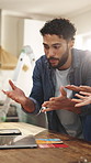 Laptop, argue and couple with paint swatch in home, shade disagreement and decision making conflict. Headache, angry or people with computer for color research, makeover budget or remodeling dispute