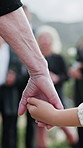 Parent, holding hands and child at graveyard for funeral ceremony, burial service and mourning loss. Person, family and kid with empathy, emotional ritual and tribute gathering at farewell memorial