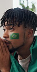 Worry, flag or man in home with soccer game, match loss or disappointment in sports tournament. Frustrated, watching or football fan in house with anxiety, score mistake or event results in Brazil.