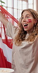 Watching tv, celebration and woman in home, soccer and cheering for goals, winning or world cup. Excited, happiness or person on sofa, football team or sports event for championship, smile or support