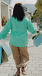Walking, smile or black woman with shopping bag on street, retail therapy or travel souvenir for holiday. Consumerism, summer vacation or person with local gift on sidewalk, explore city or tourism