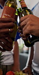 Hands, friends and toast with beer in home for celebration, reunion or party with football shirt for game. People, group and drink with beverage, alcohol or bonding for sports tournament at apartment