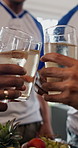 Hands, friends and toast with glasses in home for celebration, reunion or party with football shirt for game. People, group and drinks with beverage, alcohol or bonding for sports tournament at house