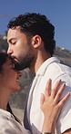 Smile, couple and kiss on forehead outdoor for love, adventure and bonding together. Happy, people and admiration with romantic gesture, partner affection and relationship commitment on vacation trip