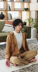 Yoga, man and breathing meditation in home for spiritual healing, inner peace and mindfulness. Yogi, calm person and zen practice on mat for stress relief, holistic wellness and align chakra in house