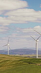 Green, wind turbine and renewable energy in farm, drone or sustainable with zero emissions in nature. Grass field, windmill and natural resource for carbon footprint in environment, space and outdoor