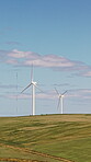 Eco friendly, wind turbine and renewable energy in field, drone and sustainable with zero emissions. Countryside, windmill and natural resource for carbon footprint in environment, space and outdoor