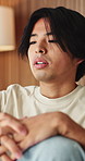 Sad, reflection and man in home, depression and mental health with loss, regret and wonder. Apartment, mistake and Asian person in lounge, mourning and nostalgia with grief, thinking and remember