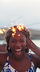 Dance, face and sparklers with woman on beach for holiday, travel or vacation in evening. Excited, fireworks and funny with group of happy friends in nature for celebration, energy or wellness
