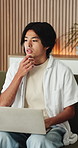 Thinking, laptop and asian man with remote work in home, social media campaign and online trend research. Planning, pc and freelancer marketer with community engagement idea, ads proposal and typing