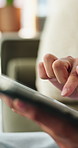 Tablet, hands and man in home with networking, texting or chatting on app with relax in living room. Digital technology, research and male person with online website for blog in lounge at apartment.