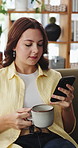 Woman, relax and coffee with phone at house for social media, browsing website and networking. Female person, beverage and mobile for communication, reading chat and notification update with message