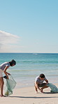 Teamwork, plastic or beach with cleaning bags for pollution, dirt or saving planet together. Volunteer, people or group with rubbish, garbage or litter on ocean coast for waste management in nature