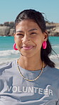 Face, woman and volunteer with smile at beach for earth day, waste management and stop pollution. Portrait, female person and happy employee for recycling, social responsibility and cleaning seashore