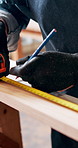 Carpenter, plank and hands with tape measure, project and woodwork or construction. Workshop, equipment and material for build with renovation, repair and handyman for furniture small business