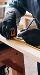 Carpenter, wood and hands with tape measure, project and woodwork or construction. Saw machine, equipment and material for build with renovation, repair and handyman for furniture small business