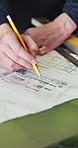 Hands, architecture and man with blueprint, writing or planning for renovation project. Closeup, engineering or person with documents for development, pencil or construction for real estate or design