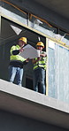 Blueprint, discussion and team of construction employees on site with planning for renovation. Architecture, paper and male civil engineers with talking for building, repairs or maintenance outdoor.