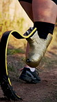 Running, fitness and athlete with prosthetic leg for workout, sprint training and exercise. Sports, outdoors and person with disability start for wellness, health and performance on nature trail