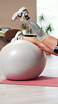 Legs, person and stretching on ball with prosthetic for fitness, exercise and physical therapy. Amputee, equipment and patient with disability for balance, improve mobility and physiotherapy session
