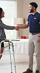 Woman, walker and handshake with physiotherapist for healthcare, amputee and happy for consultation. Greeting, client and person with disability in office, smile or shaking hands for physical therapy