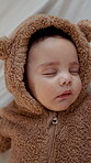 Development, sleeping and quiet with baby in nursery of home for dreaming, growth or peace. Asleep, children and nap time with infant boy in bear onesie for break, comfort or rest from above