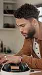 Man, laptop and typing with remote work from home with report, notes or checklist for project management. Person, freelance writer and computer with editing process, insight and article at apartment