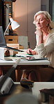 Laptop, logistics and thinking with woman in office for delivery or distribution tracking. Computer, supply chain and typing with mature courier in warehouse for shipping management or service