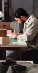 Ecommerce, man and writing in office with logistics, administration and report for small business. Person, supply chain notes and check order in startup with package review, courier or shipping info.