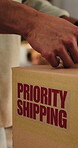 Logistics, box or hands with shipping label in office, package distribution or mailing address info. Ecommerce, packaging process or person with sticker for priority delivery, order details or export