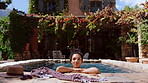 Happy woman, relax and vacation in pool for summer holiday or cool off at luxury resort. Female person, tourist or traveler chilling in poolside for weekend travel, outdoor getaway or swimming trip
