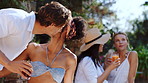 Friends, hug and greeting in backyard with summer holiday, social gathering and bonding together. Happy, people embrace and party outdoor at home with kiss, conversation and reunion for vacation.