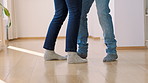 Legs, couple and dance in home for love, anniversary and bonding together for healthy relationship. Man, woman and moving to music with feet for groove, romantic rhythm and celebration in house