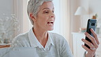 Senior, happy woman or talking with phone for video call, conversation or communication in home. Elderly, female person or speaking with smile on mobile smartphone for virtual chat, app or discussion