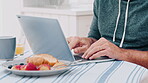 Typing, laptop and breakfast with hands in home for freelancer, food blogger and social media. Online post, remote worker and email with person and tech in apartment for recipe, health and writer