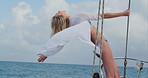 Happy, woman and freedom on yacht with ocean, summer holiday outdoor and travel adventure for getaway. Carefree, person and sailing on boat with open arms, scenic view and tropical vacation at sea.