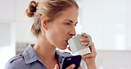Phone, thinking and happy woman in kitchen, drinking coffee or check notification for online dating. Home, morning beverage or person with mobile for social media, typing or response idea for match